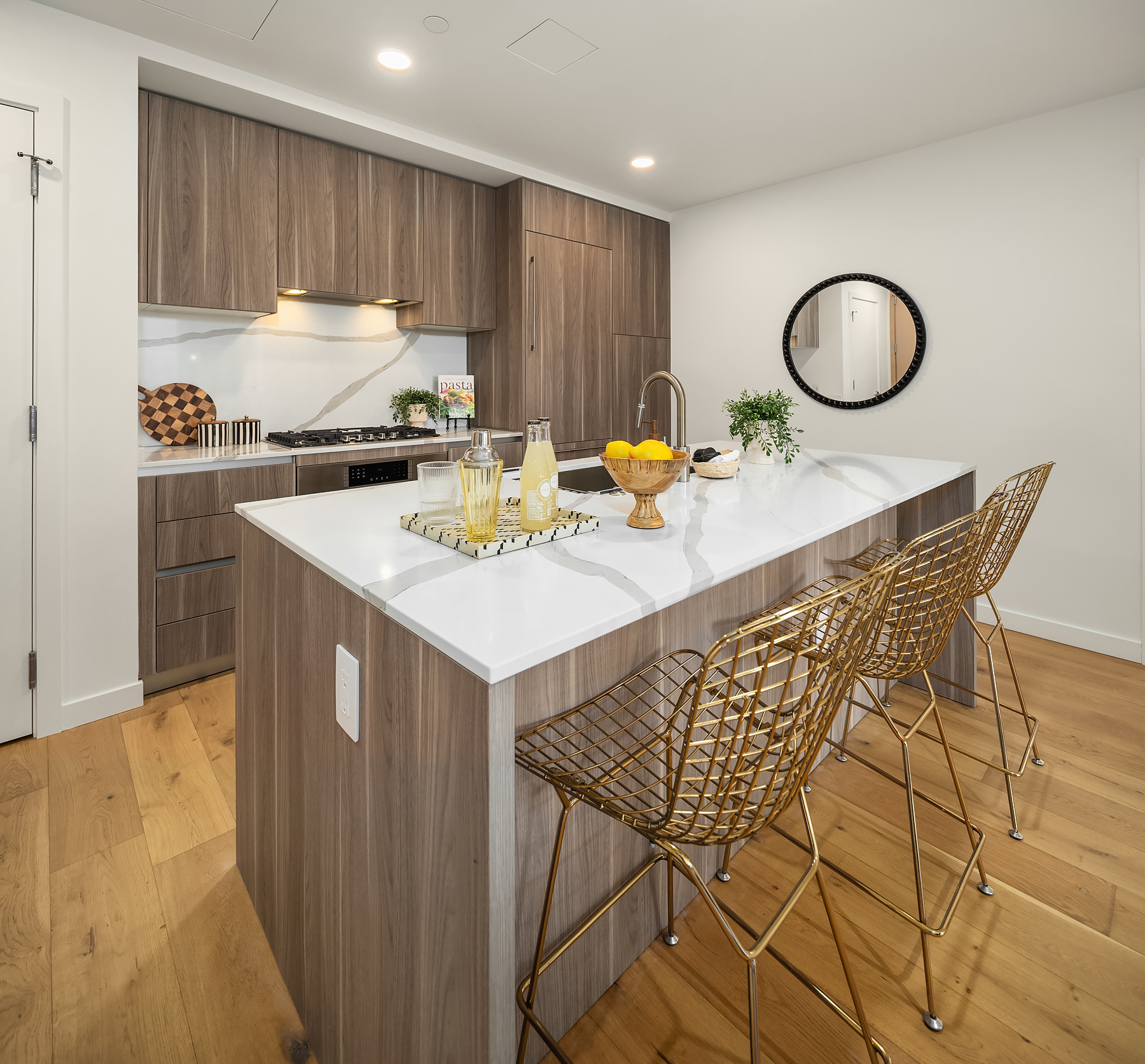 Stone-topped island with seating and custom Italian cabinetry