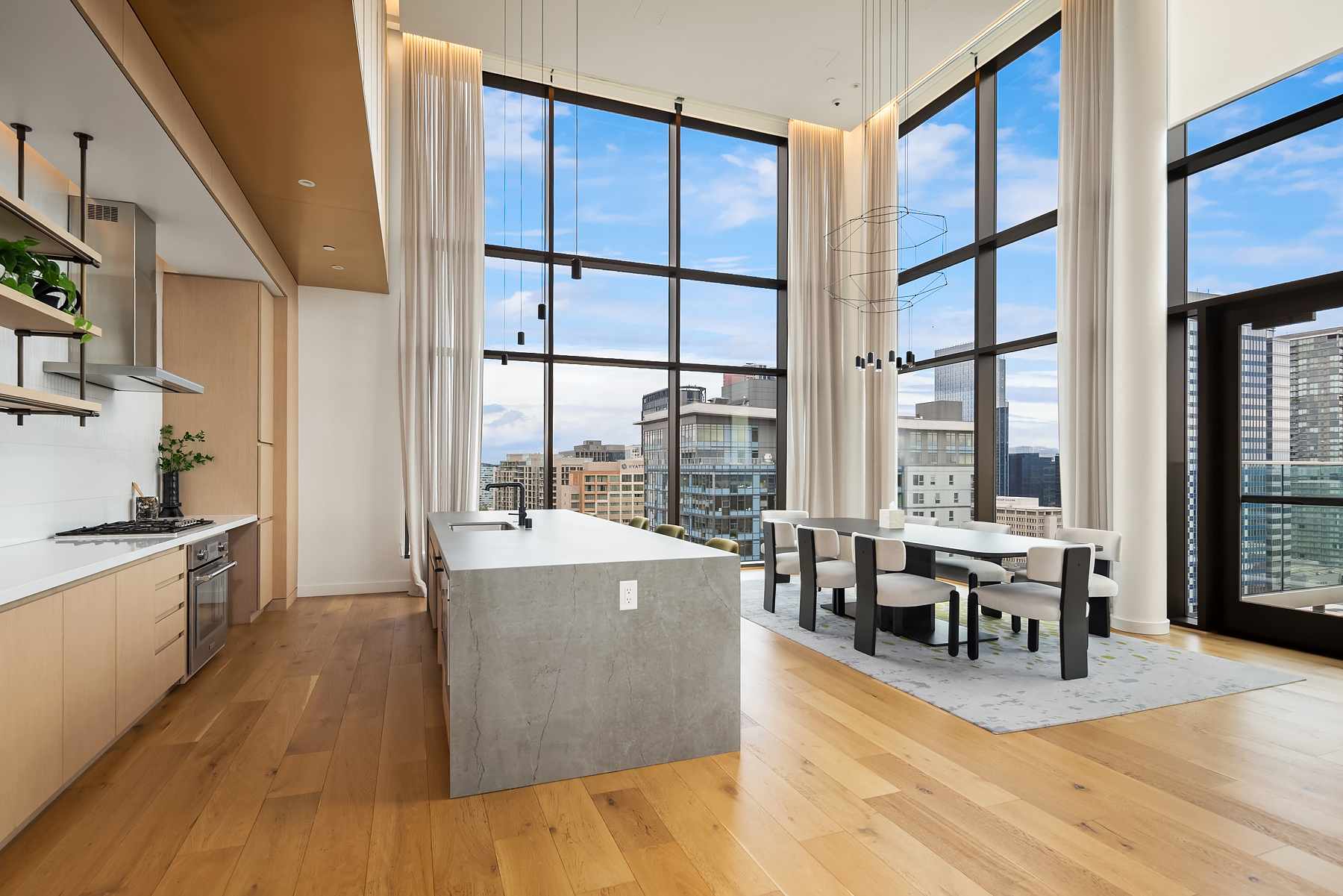 SkyClub chef's kitchen and dining with floor-to-ceiling glass