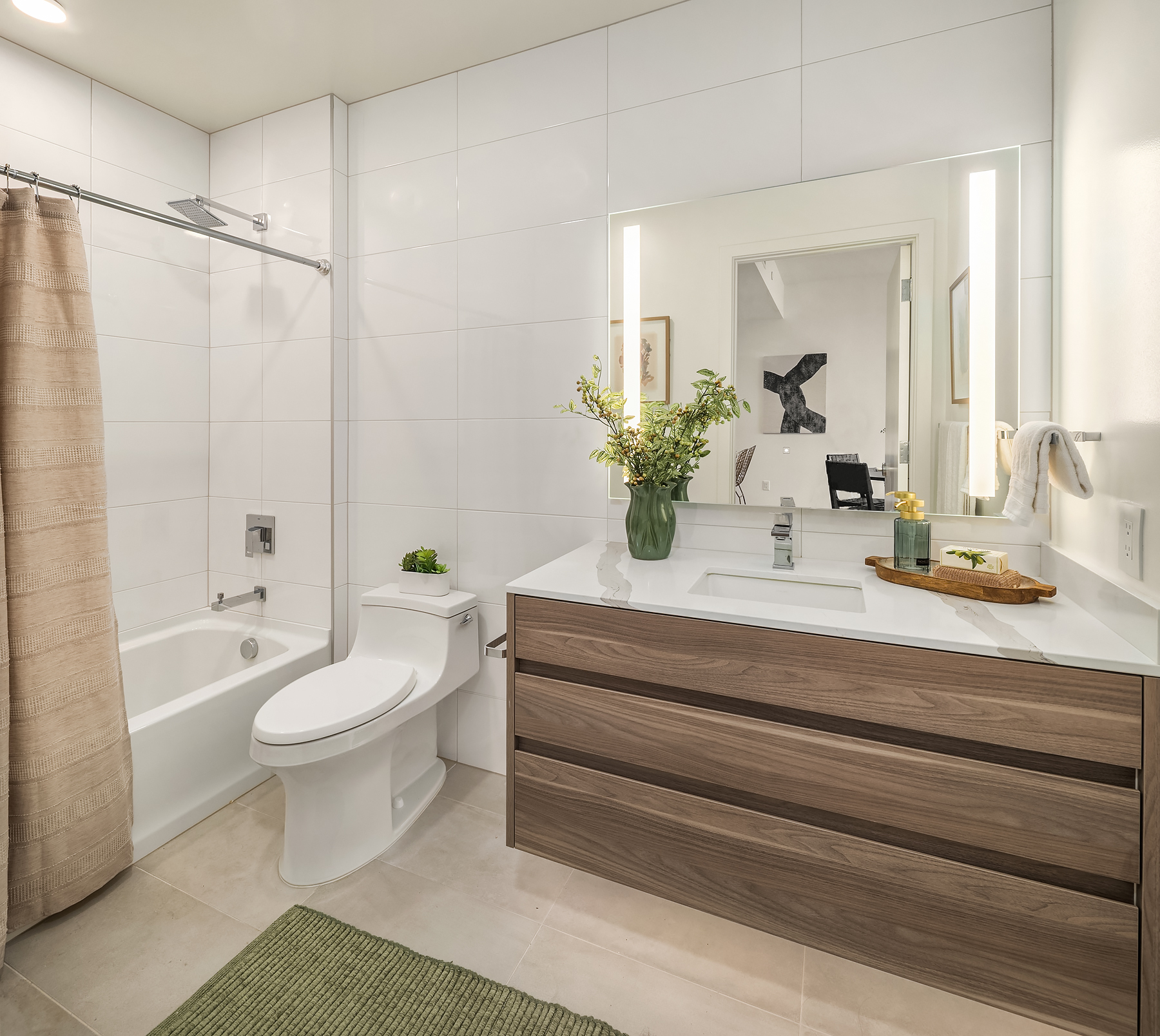 Spa-inspired bathroom with floating vanity and lit mirror